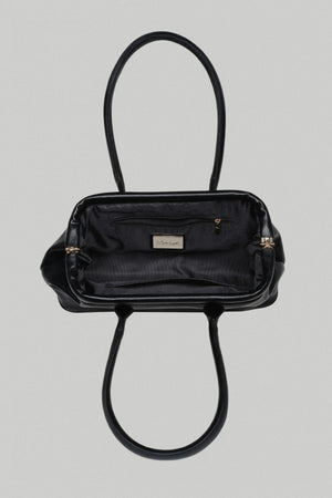 Black handbag with gold accents on a light gray background