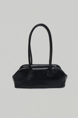 Black handbag on a light gray background