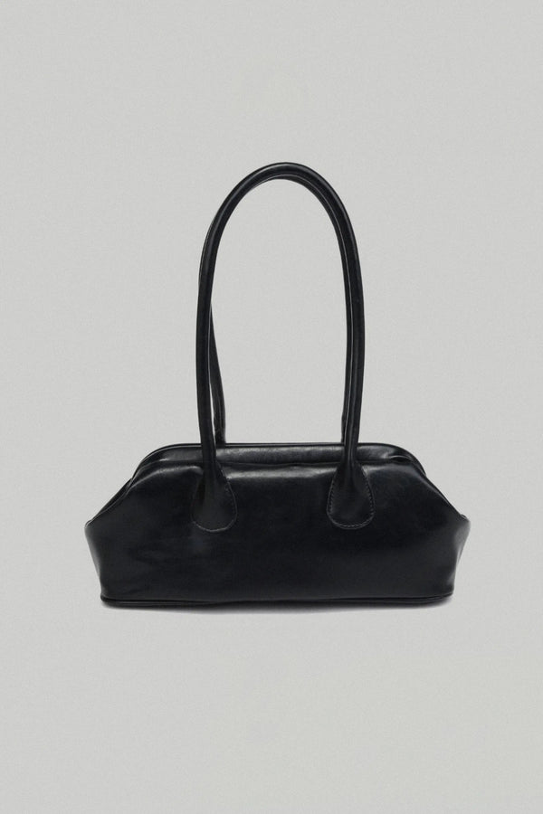 Black handbag on a light gray background