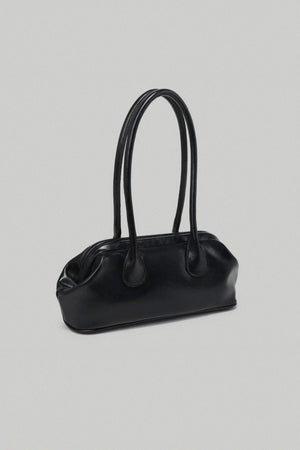 Black handbag on a light gray background
