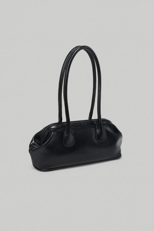 Black handbag on a light gray background