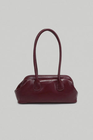 Burgundy handbag on a light gray background