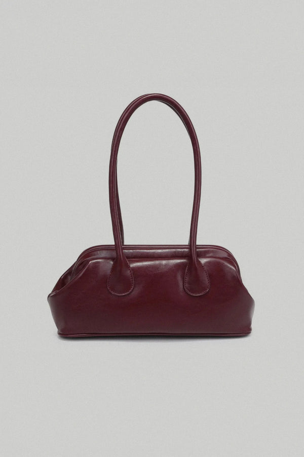 Burgundy handbag on a light gray background